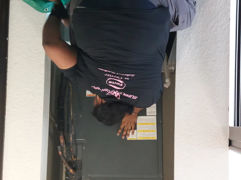 AC cleaning service technician inspecting air conditioning system in Miami home