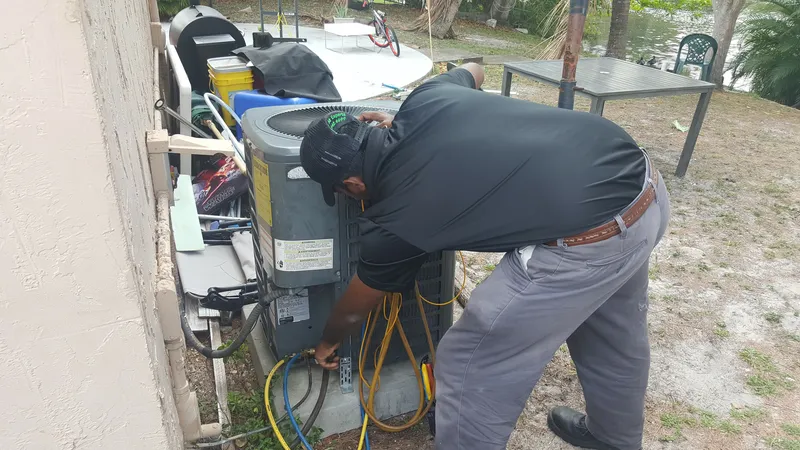 HVAC technician checking AC valves during ventilation system cleaning