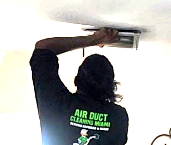 Step 1 — Air Duct Cleaning Miami technician removing supply vent covers for camera scope