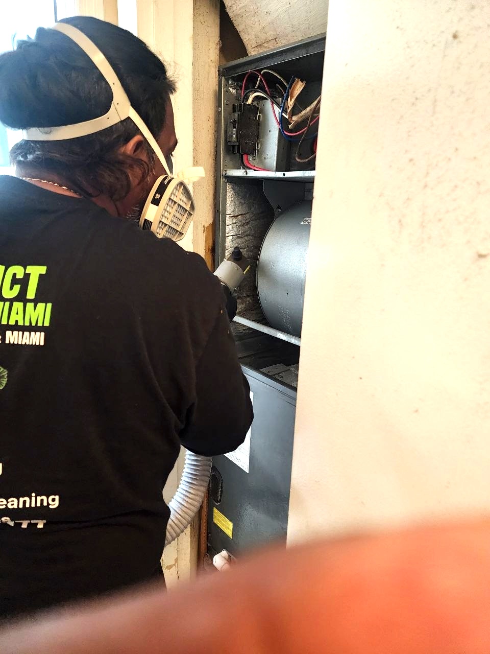 Technician sanitizing AC unit and ductwork to kill mold and bacteria