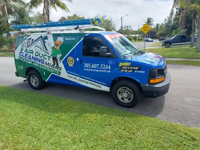 Air Duct Cleaning Miami branded service van with license #CAC1817115 parked outside a South Florida home